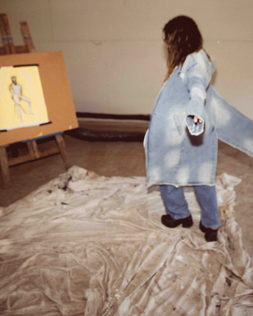 Pheobe Claire takes a break from painting and dances in circles in a fallen broken street denim trench coat
