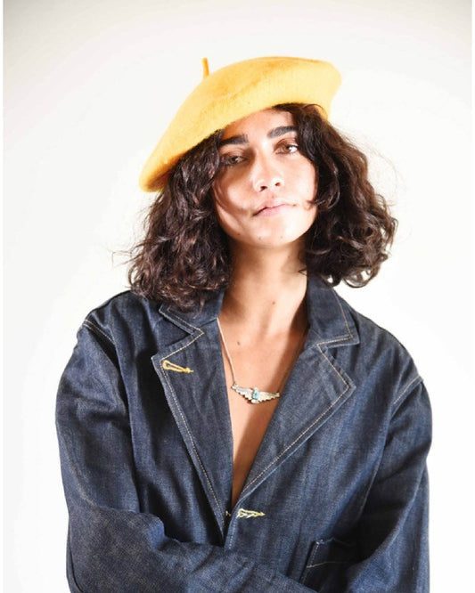 Model wearing The Belle Beret – Caramel Wool styled with a loose button-down shirt. This wool beret adds soft structure and a Parisian twist to the outfit, ideal for cool-weather styling.