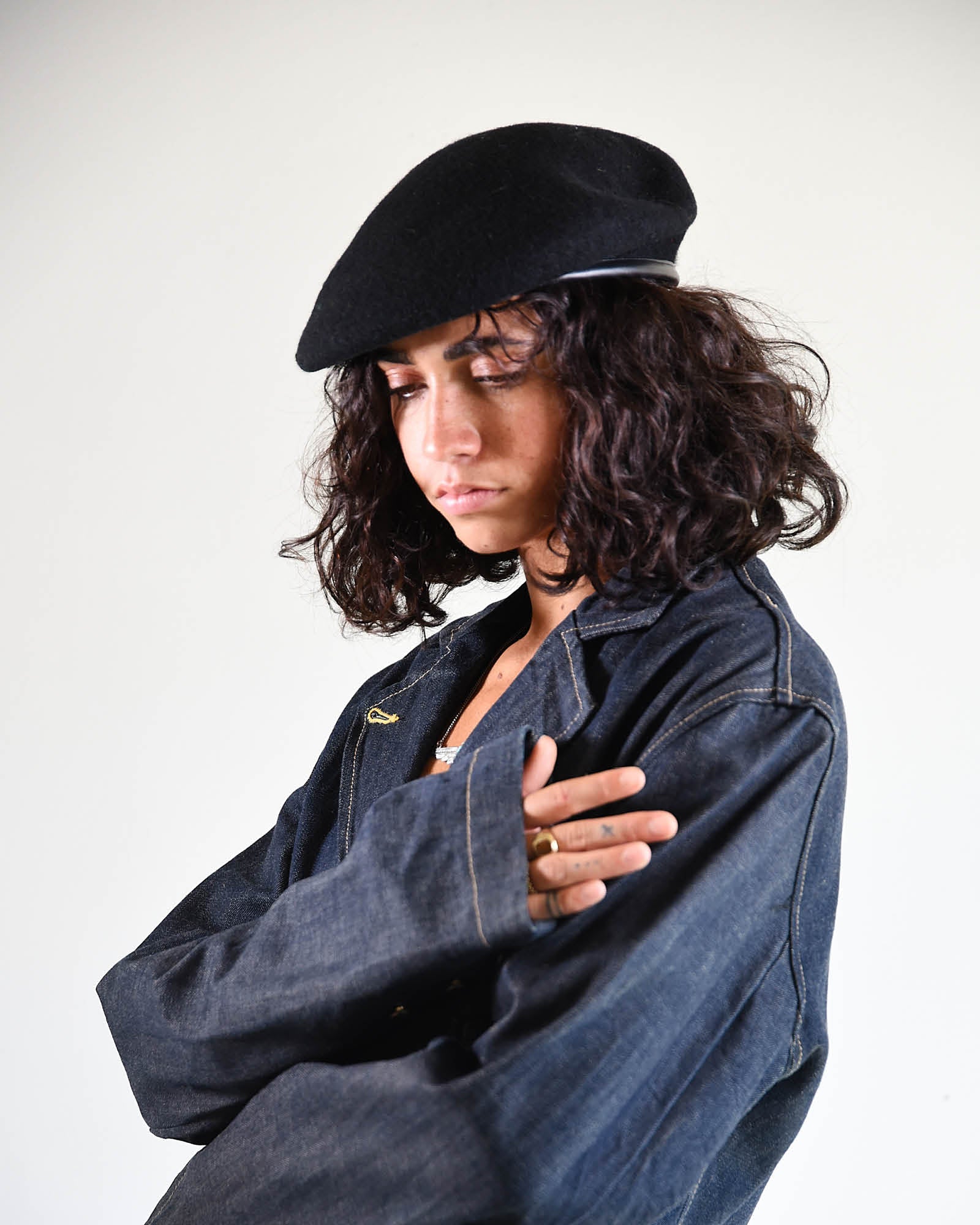 Side profile shot showing the soft structure and curved leather edge of The Château Beret.
