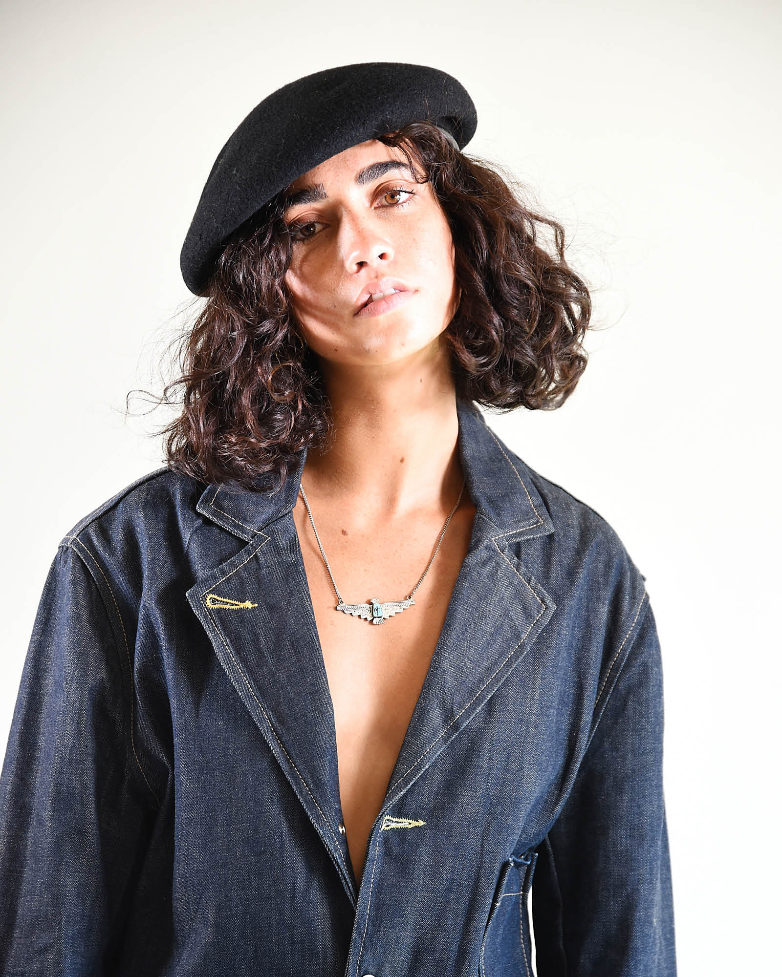 Natural light image showing the beret’s fit and texture on curly hair.