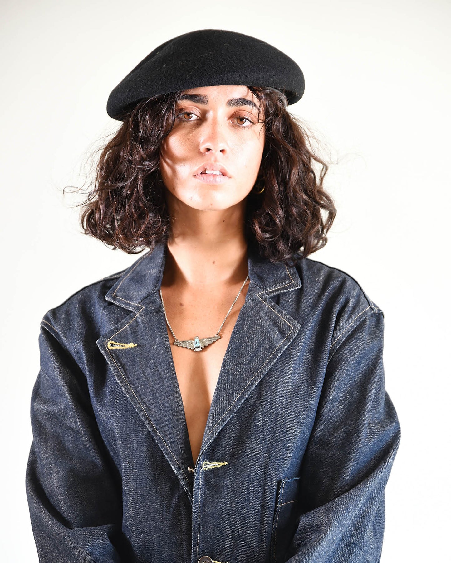 Slightly angled portrait of model with relaxed stance, showing the beret’s versatility.