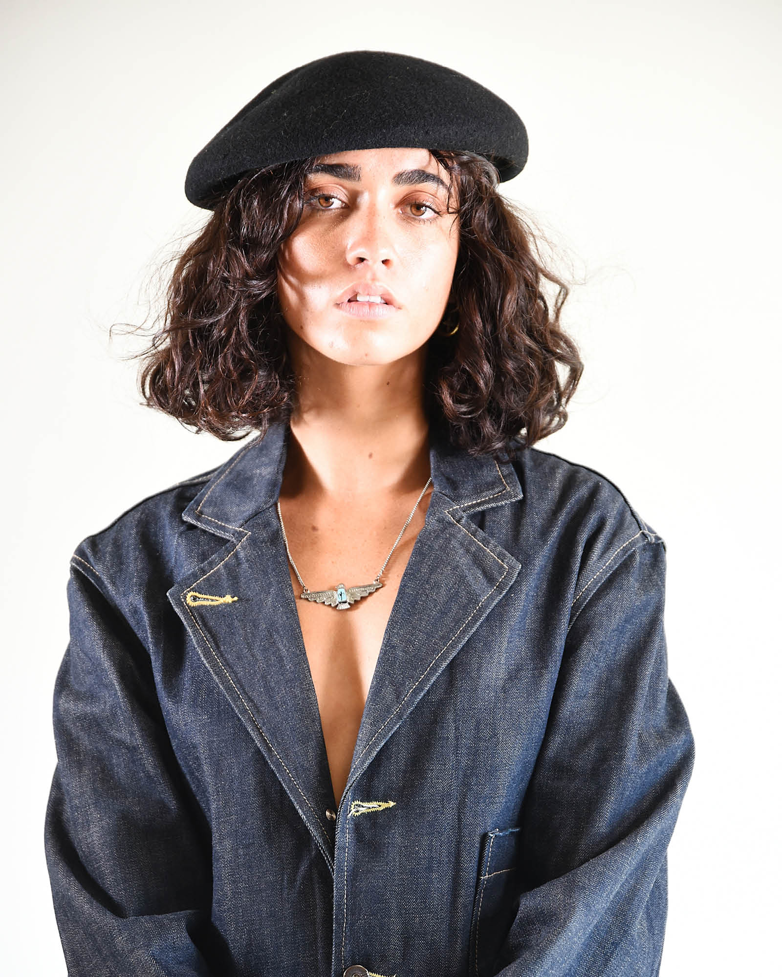 Slightly angled portrait of model with relaxed stance, showing the beret’s versatility.