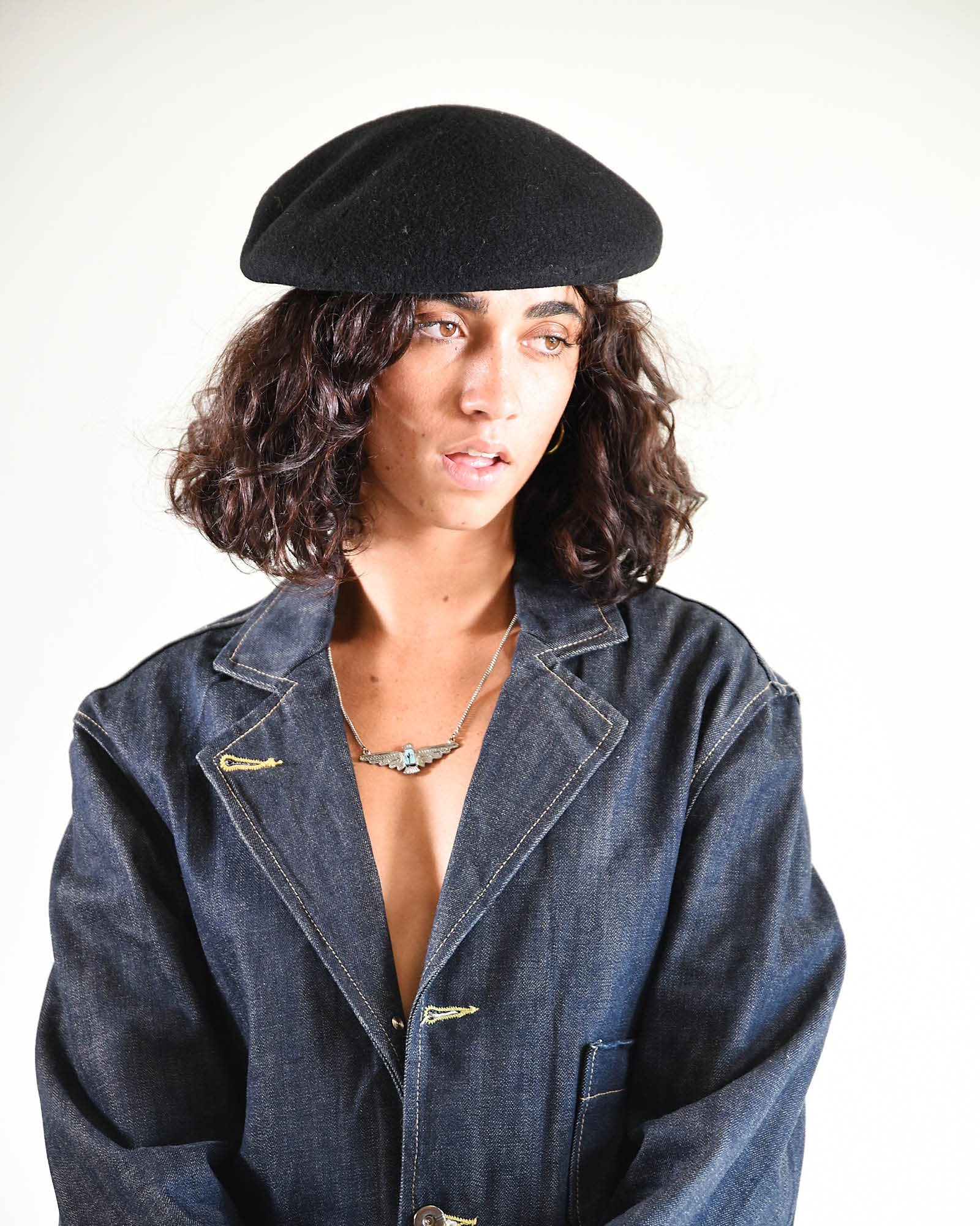 Smiling model in navy layering pieces, showing effortless winter styling with The Château Beret.