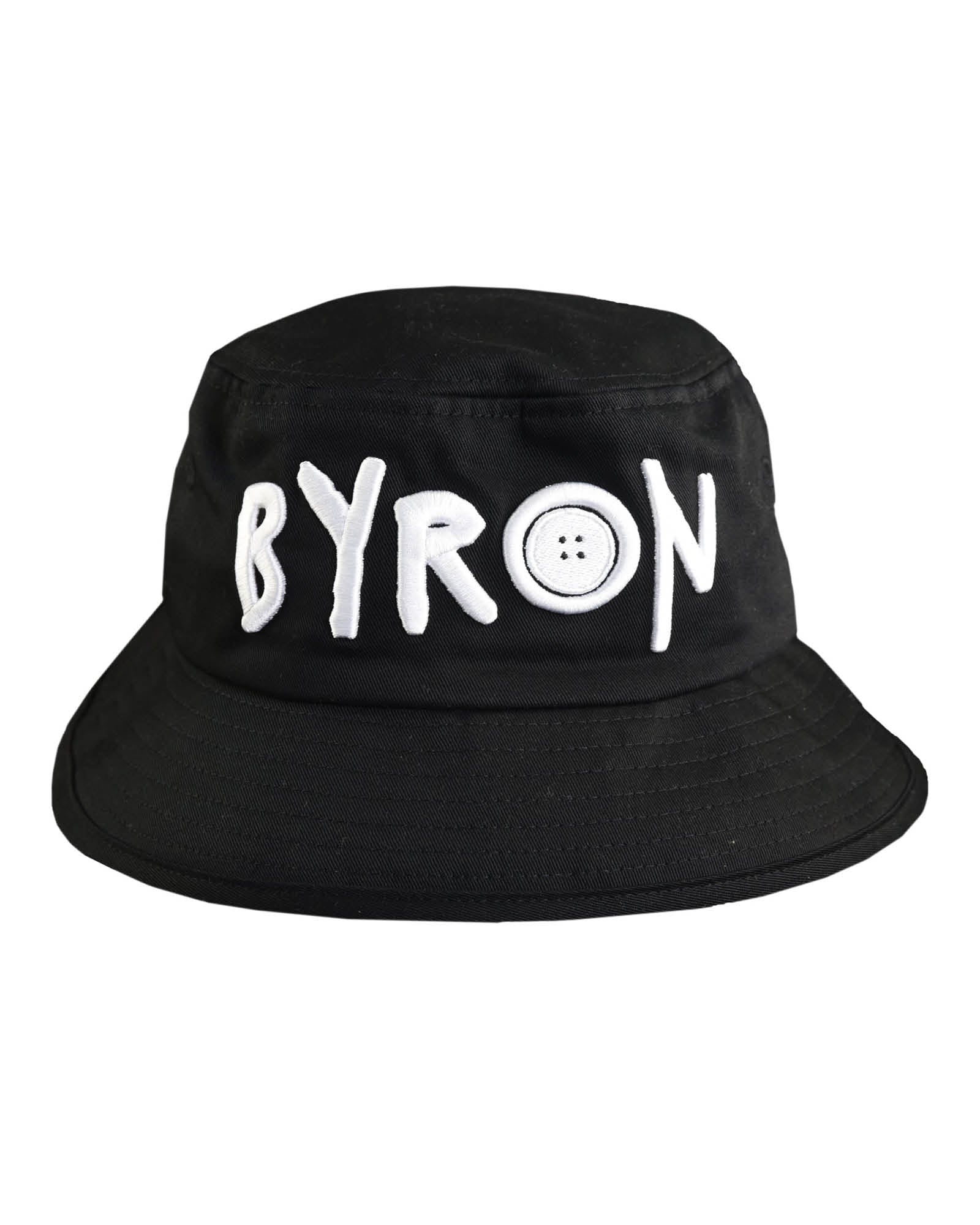 Black cotton bucket hat with bold white 'BYRON' embroidery from Fallenbrokenstreet, photographed from the front. Designed to represent Byron Bay with relaxed style and comfort.