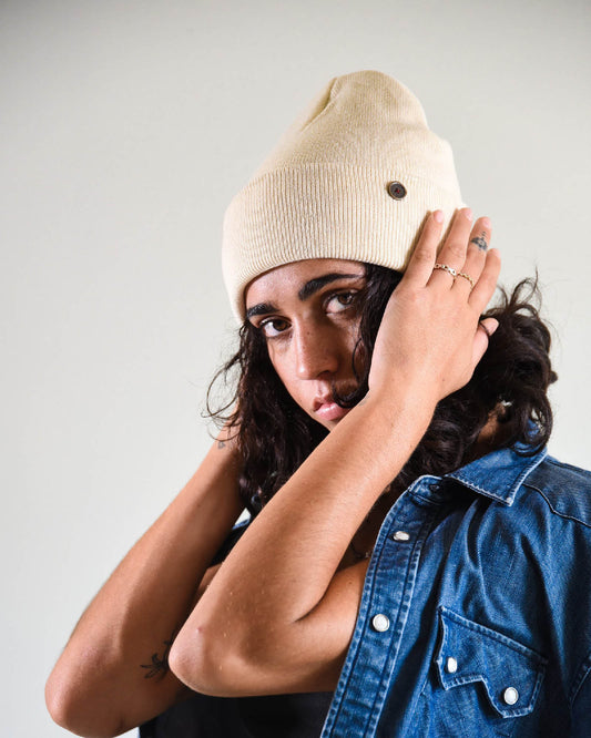 Side View on woman Beige Lucks Beanie in premium wool blend, ribbed knit design, unisex flexible fit.