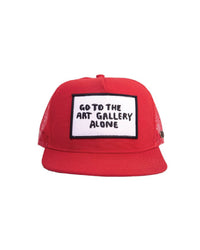 Close-up of the FBS x Marty Baptist Art Gallery Cap in bold red with a structured foam front. This hat features a striking embroidered patch that reads “Go to the art gallery alone,” offering a thought-provoking statement in classic Baptist style. Designed in collaboration with artist Marty Baptist, the trucker cap includes a breathable red mesh back, a sturdy pre-curved brim, and an adjustable snapback closure for all-day comfort. Ideal for artists, freethinkers, and streetwear fans alike, this cap is made