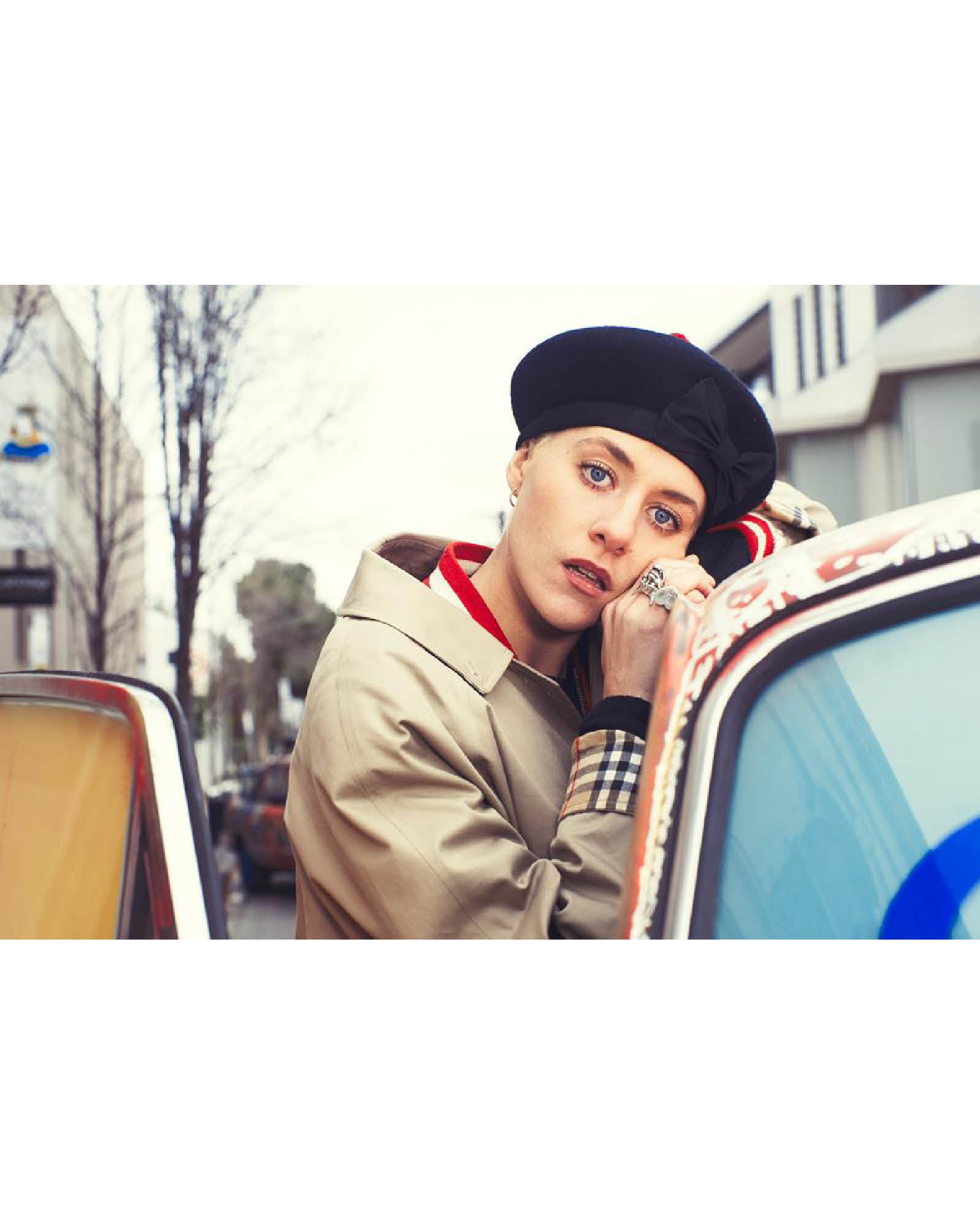 The Minnie Beret styled in an urban setting by FallenBROKENstreet. Classic black wool with red pom-pom and bow detail. Vintage-inspired accessory with playful modern edge.