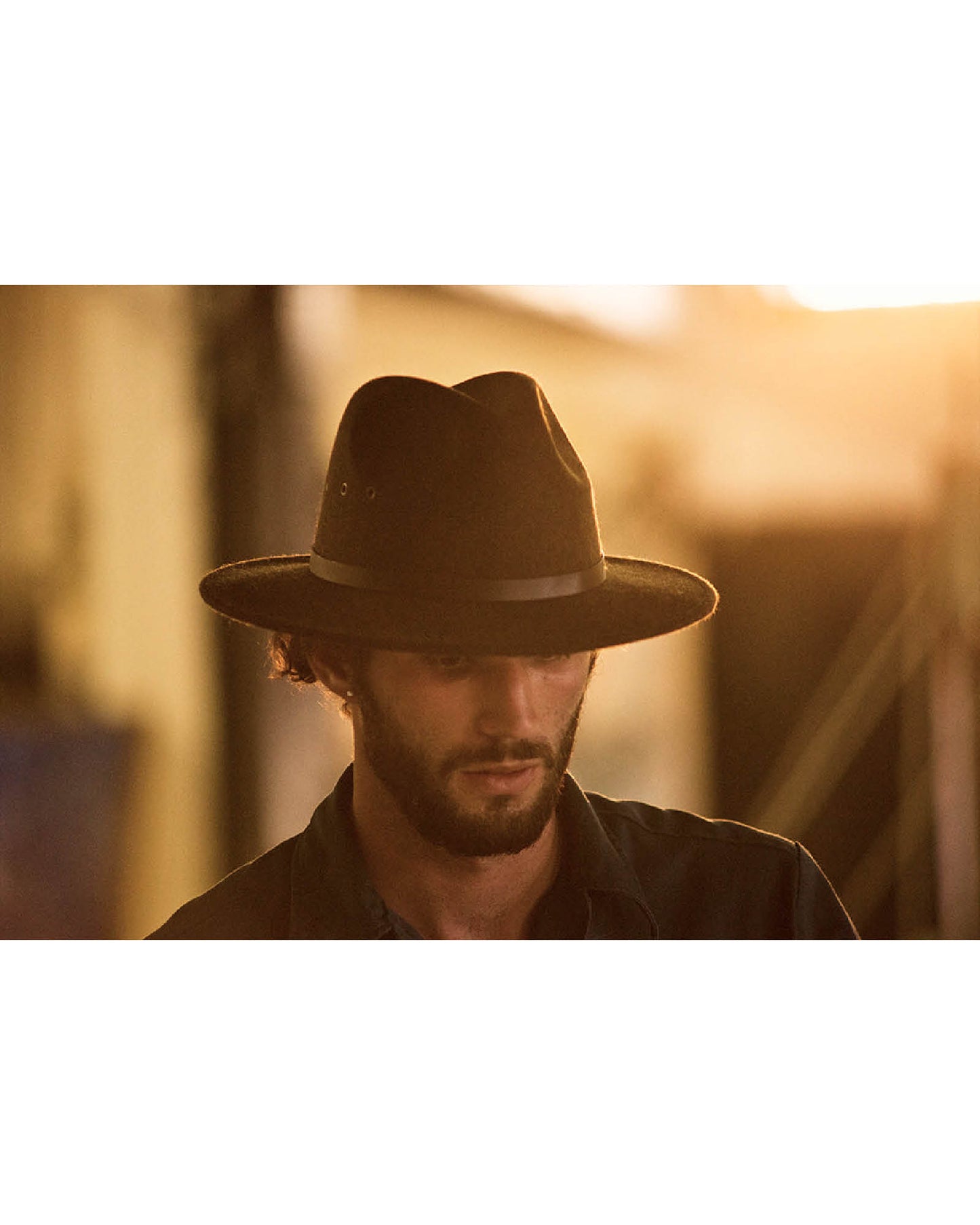 Model wearing The Crushable Ratatat Felt Hat – Mottle Brown. Australian wool felt fedora with leather band and soft, crushable structure.