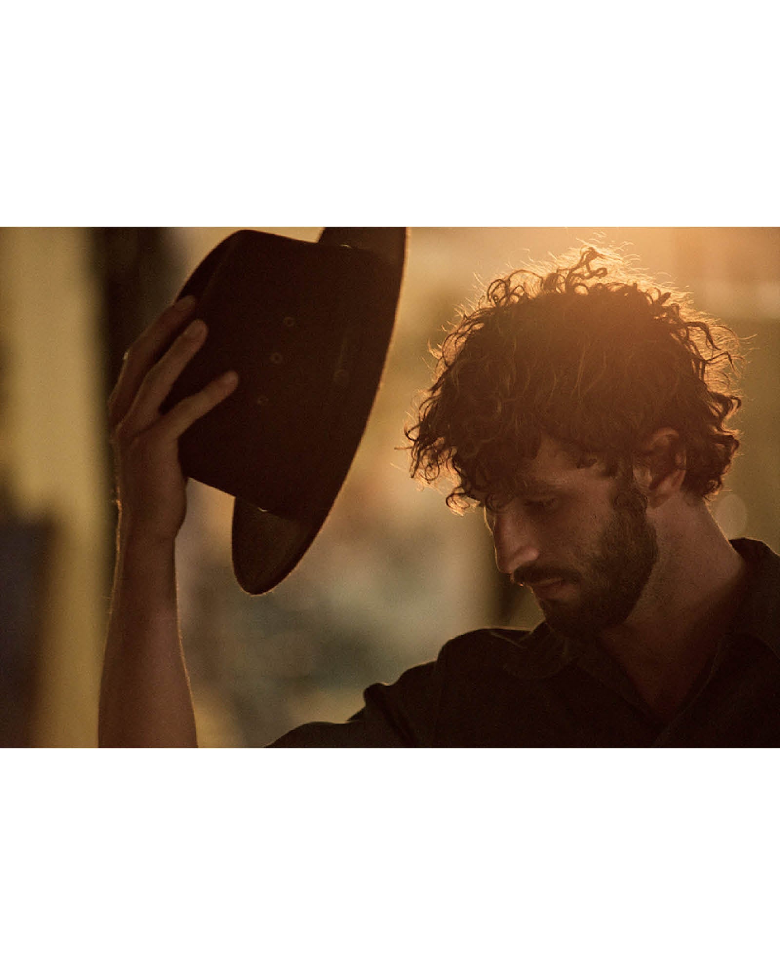 Model wears fallenbrokenstreet packable brown fedora in golden light