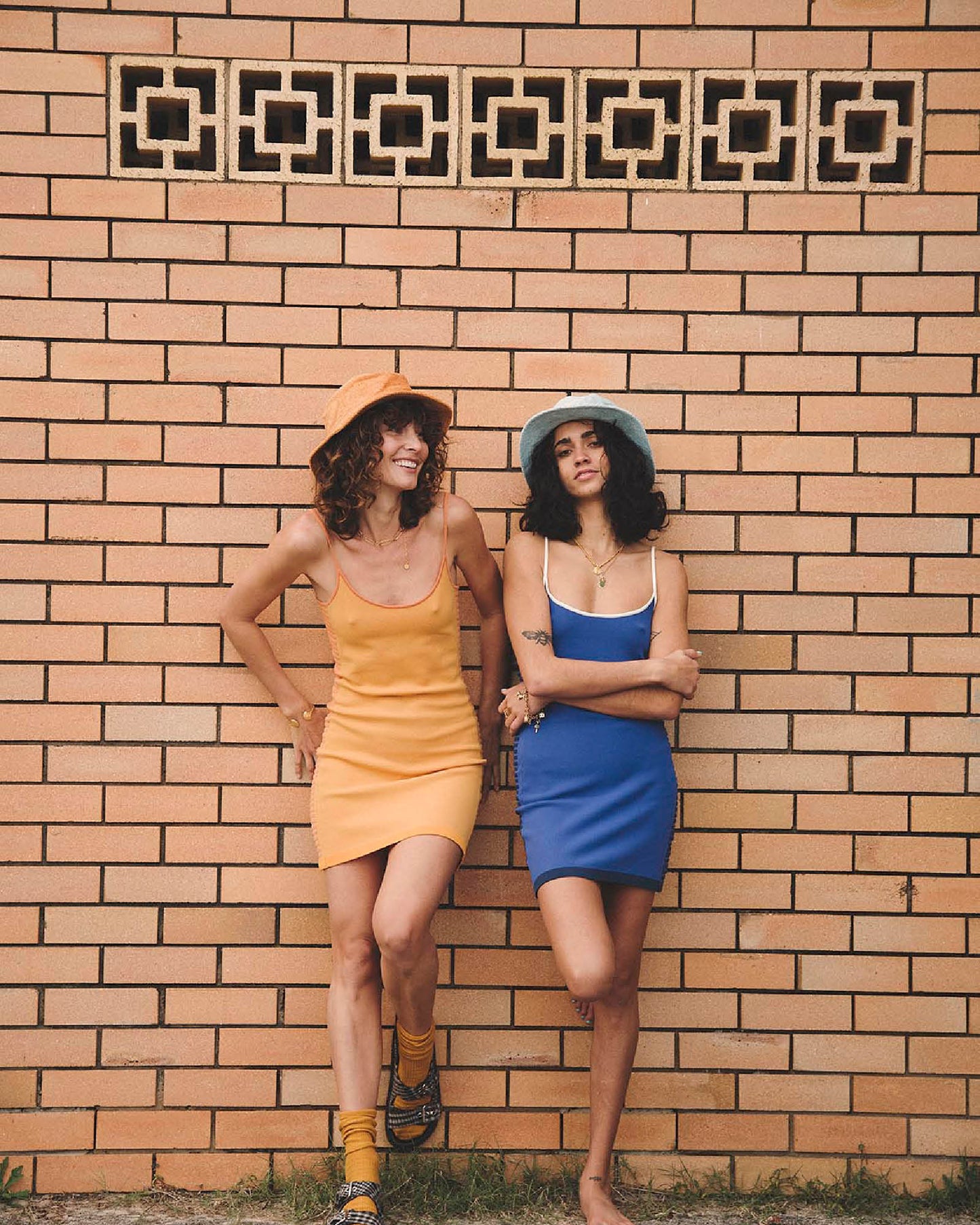 Models side by side wearing Saturday Bucket Hat – Blue and Saturday Bucket Hat – Tangerine by FallenBROKENstreet. Wide brim cotton chenille summer hats with UPF 50+ sun protection, designed for playful festivals, coastal escapes, and relaxed weekend style.