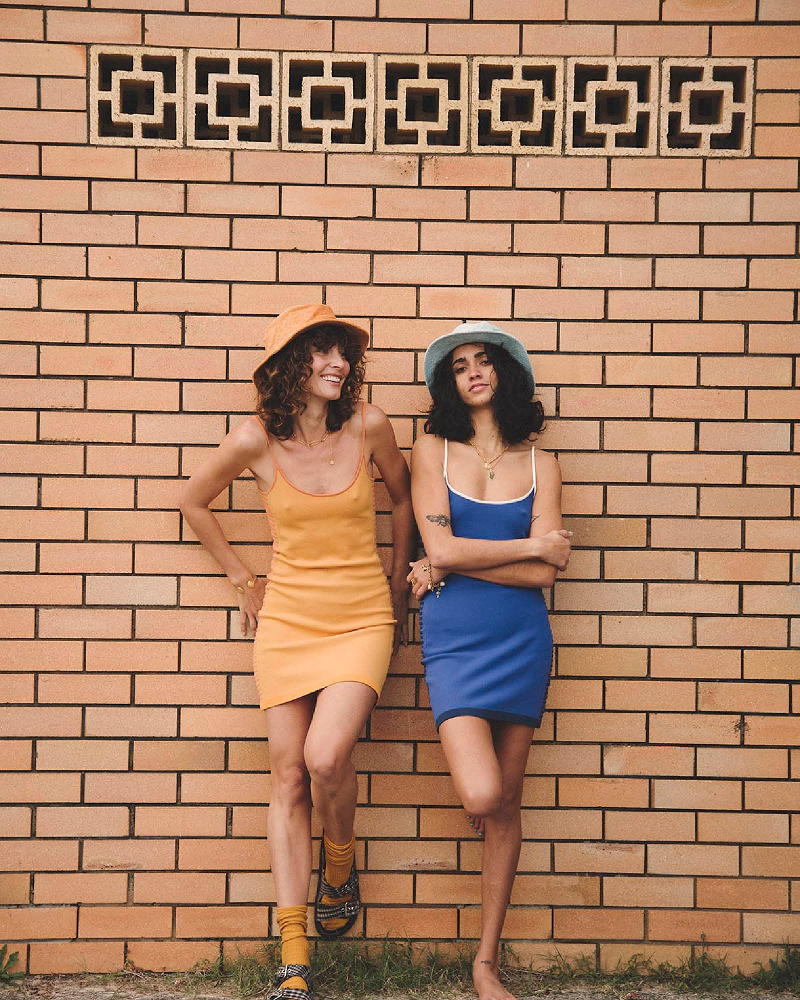 Models side by side wearing Saturday Bucket Hat – Blue and Saturday Bucket Hat – Tangerine by FallenBROKENstreet. Wide brim cotton chenille summer hats with UPF 50+ sun protection, designed for playful festivals, coastal escapes, and relaxed weekend style.