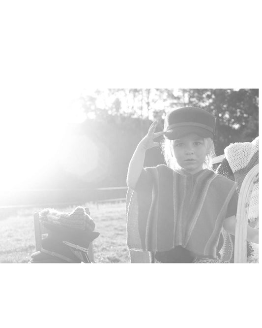 Child wearing Slipway Grey cap outdoors in soft light