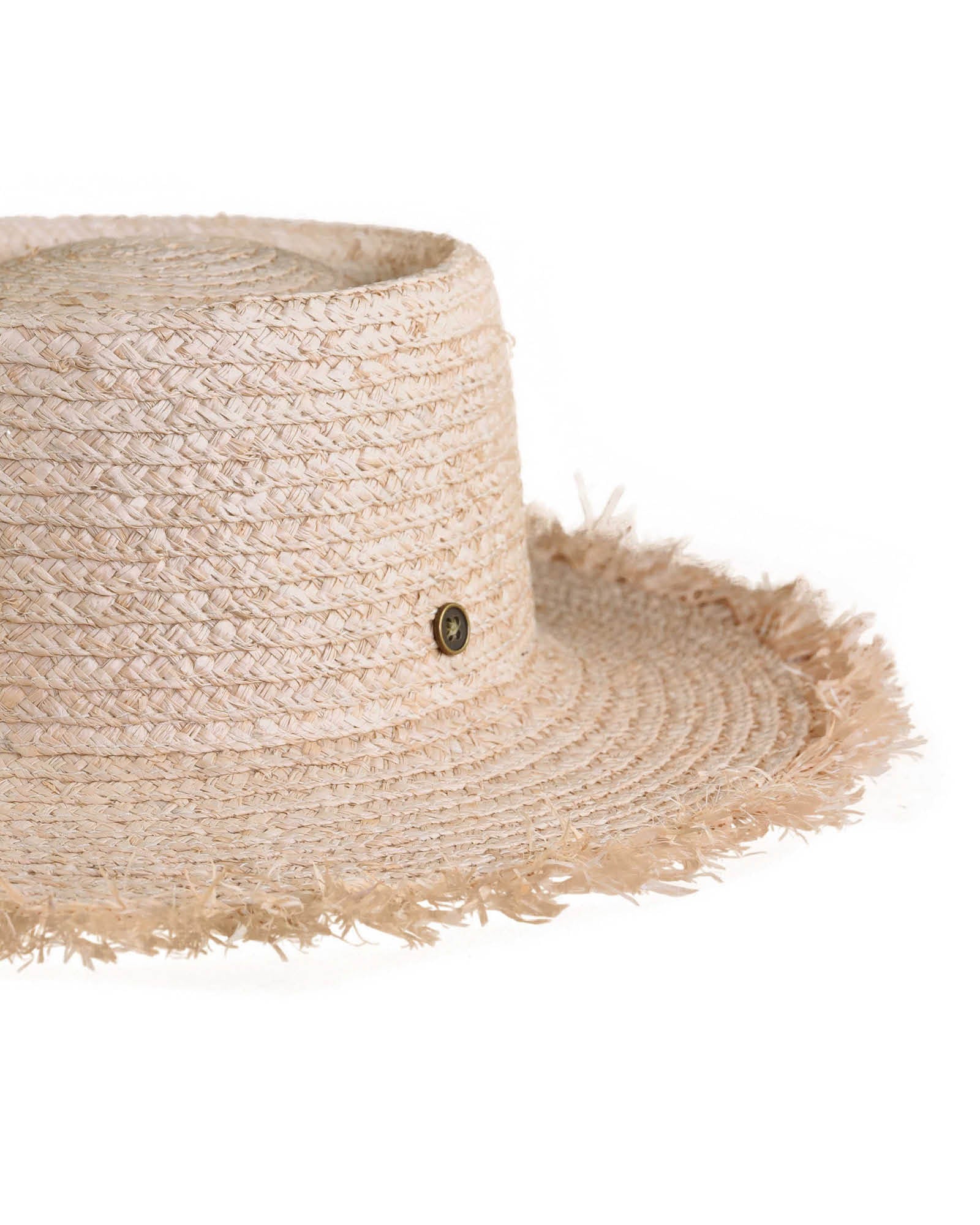 Side profile of The Seeker Straw Hat showing the textural raffia weave, frayed edge, and subtle elevation with its handcrafted detailing.