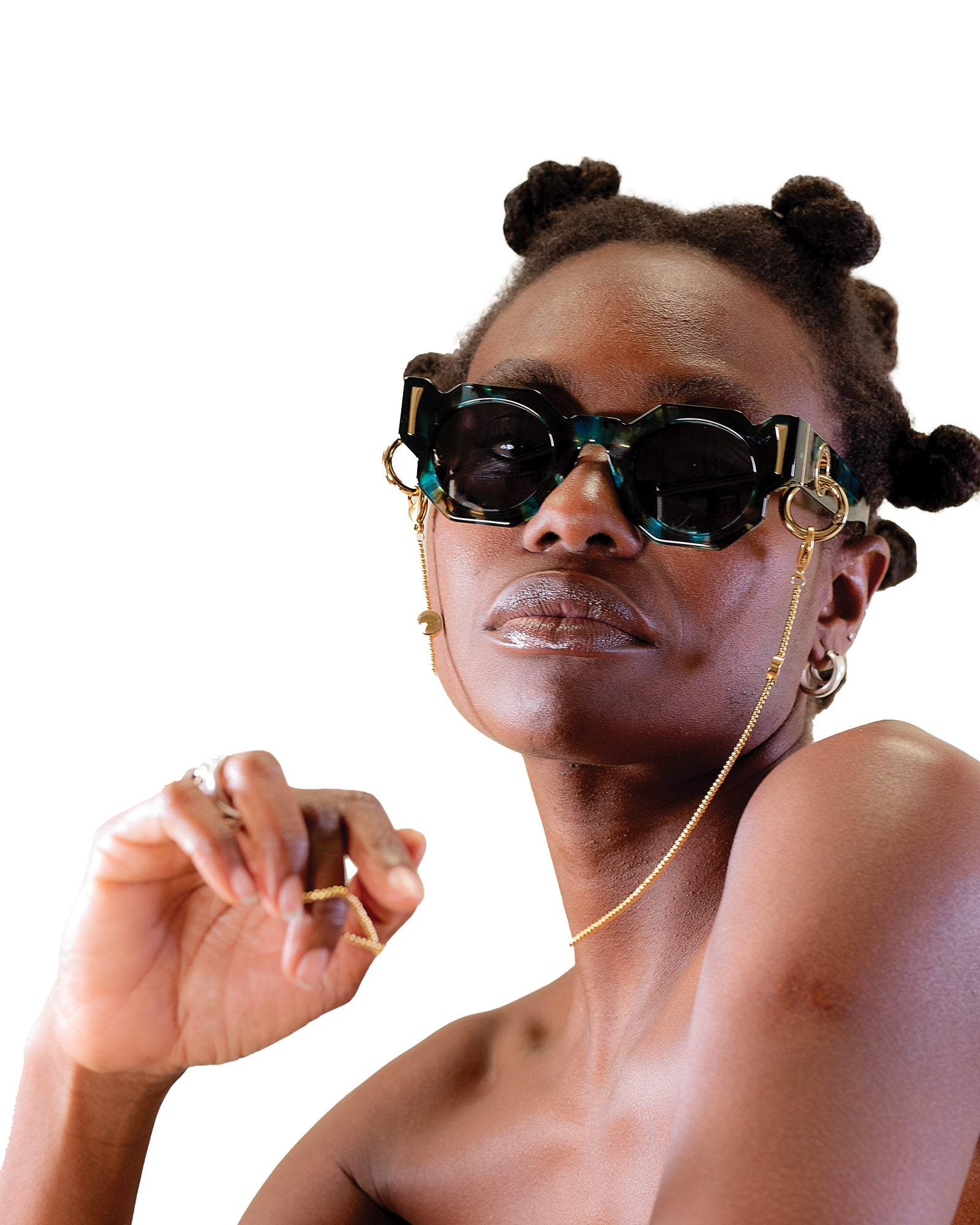 Model wearing THE COSMOS – Galaxy/Black sunglasses with a bare shoulder pose and bold expression. Showcases fit and chain compatibility on the face. Great for lifestyle and product context on Shopify. Galaxy pattern on the acetate frame clearly visible under light.