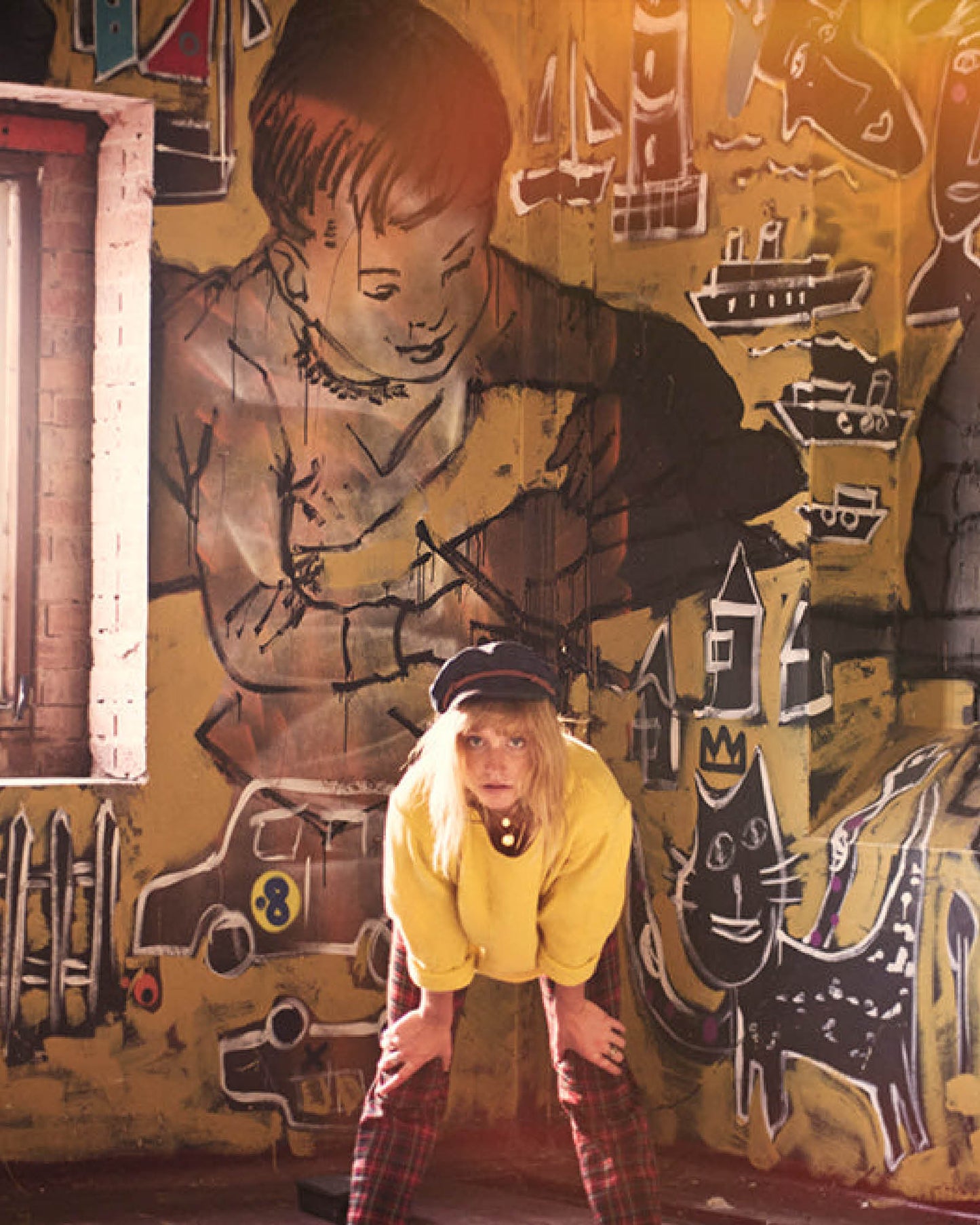 Lifestyle photo at the David Bromley Estate featuring artist wearing The Original Kyte Cap – Dark Indigo by FallenBROKENstreet. Denim design with rope detail.