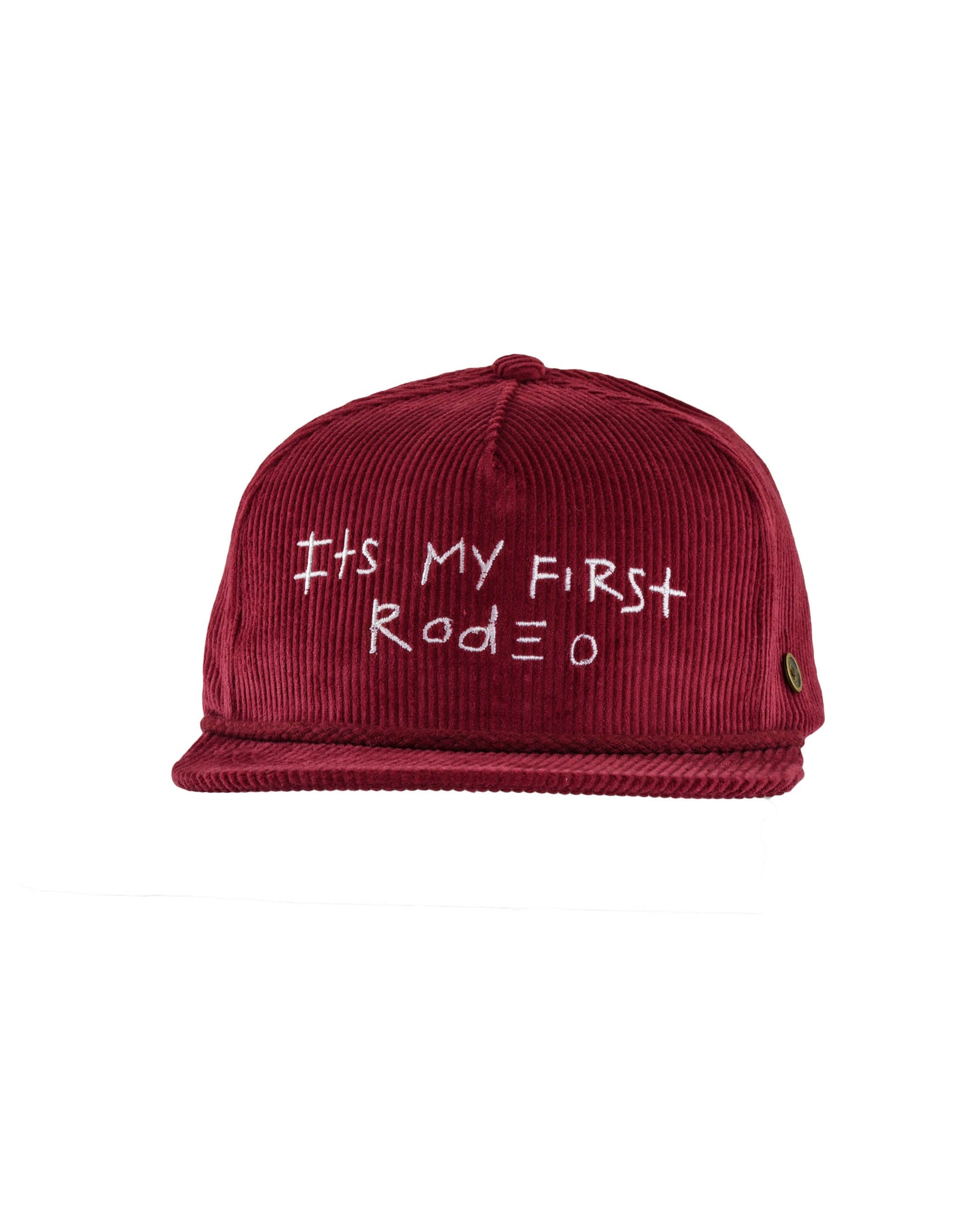 Front view of a wine red corduroy cap with “It’s My First Rodeo” embroidered in white.