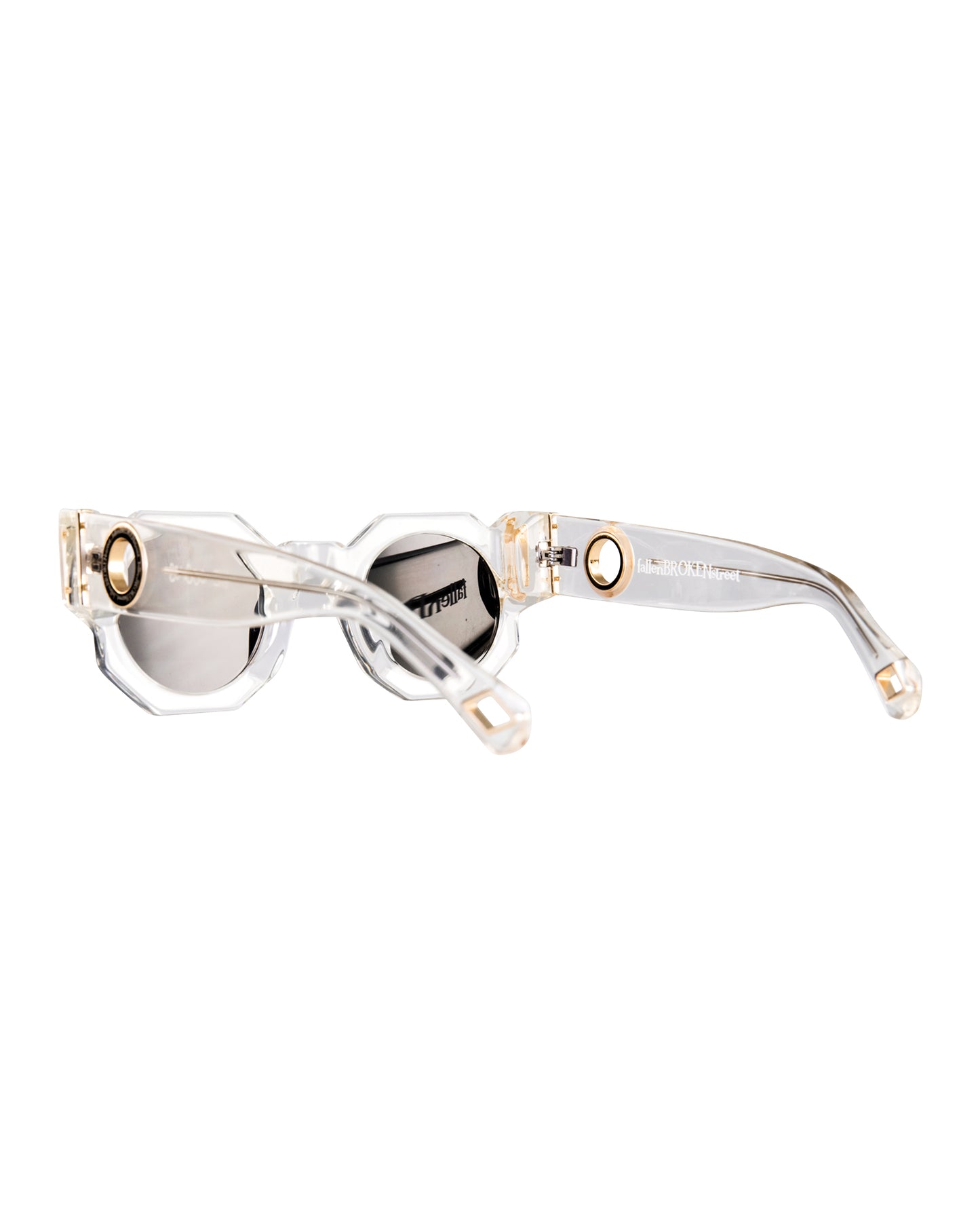 Overhead angled shot of The Cosmos sunglasses in Skywalker/Black. Showcases the balance of matte black lenses against the crystal-clear acetate arms with embedded gold detailing. Perfect for showing structural harmony and design versatility.