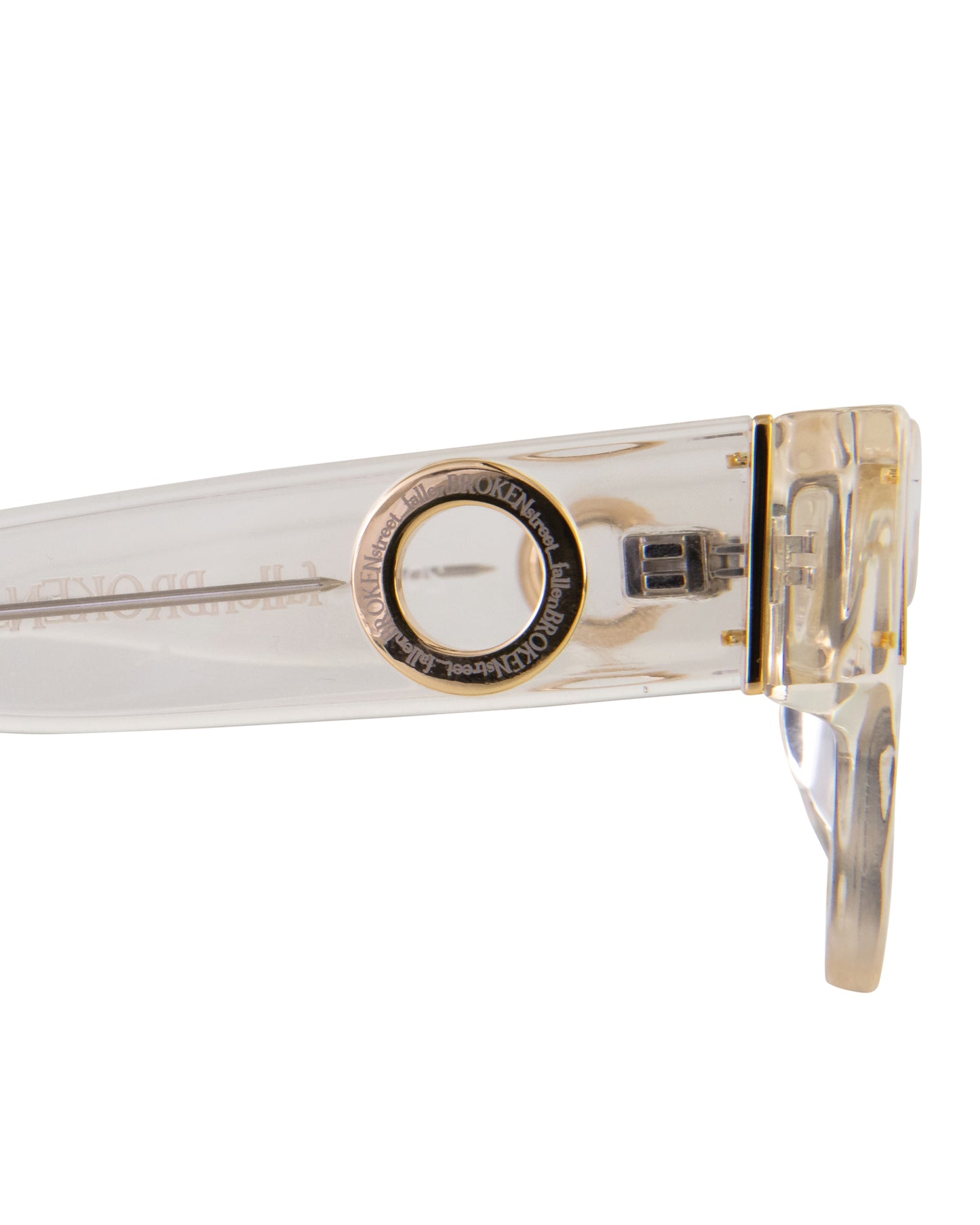 Macro image of temple detailing from The Cosmos sunglasses – Skywalker/Amber. Gold finishings and chain-ready loop captured clearly. Also shows subtle tonal gradient in acetate, ideal for highlighting premium elements.