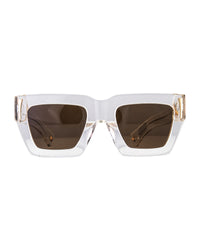 Front view of The Mischief – Skywalker/Amber sunglasses with white acetate frame and warm amber lenses. Set against a soft grey background, showcasing gold accents and bold silhouette.
