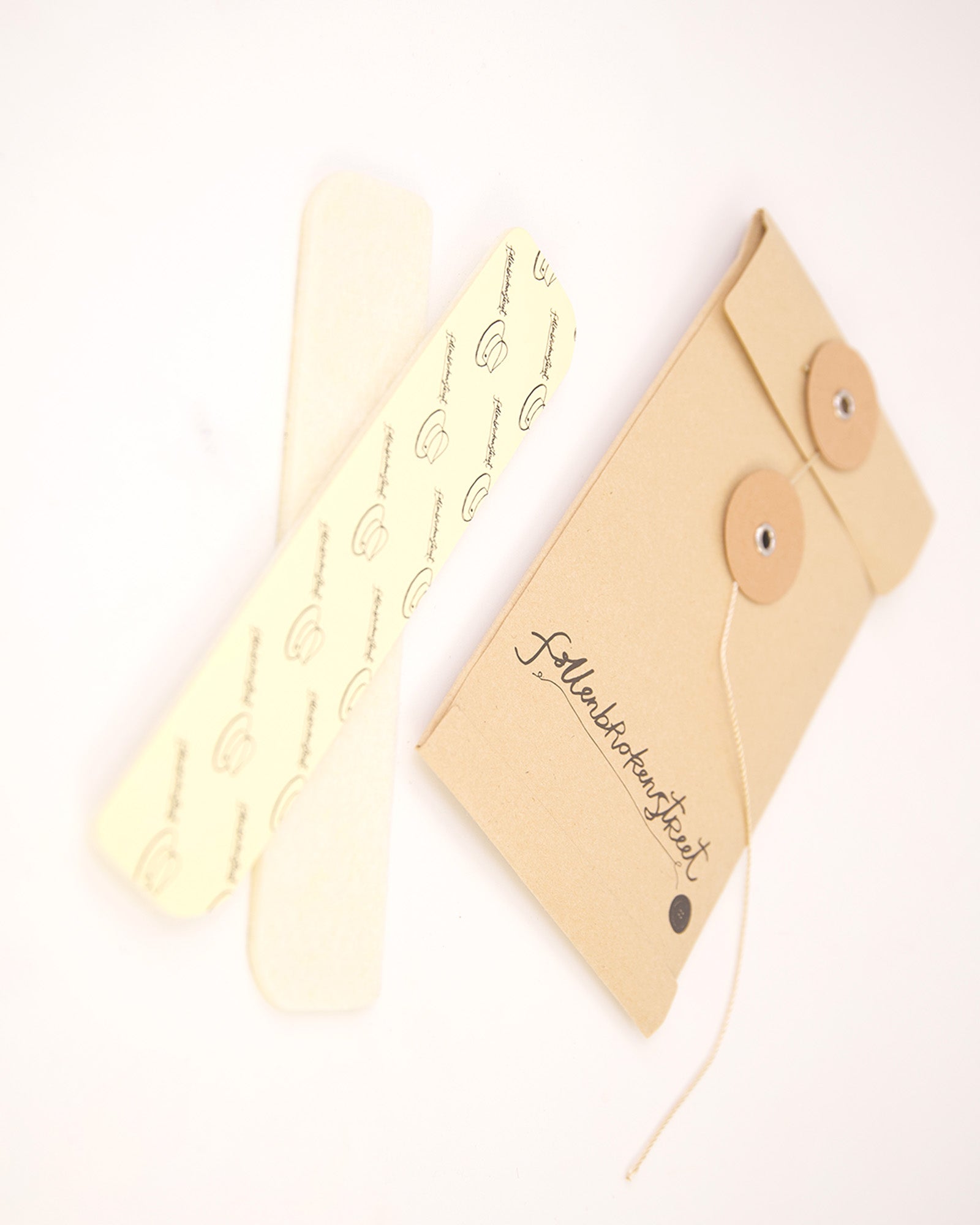 Angled photo of natural hat filler strips next to recycled packaging. Fallenbrokenstreet’s fillers reduce hat size comfortably while blending seamlessly under sweatbands. The neutral colour makes them perfect for both dark and light hat linings. Great for online listings, size support pages, and product recommendations.