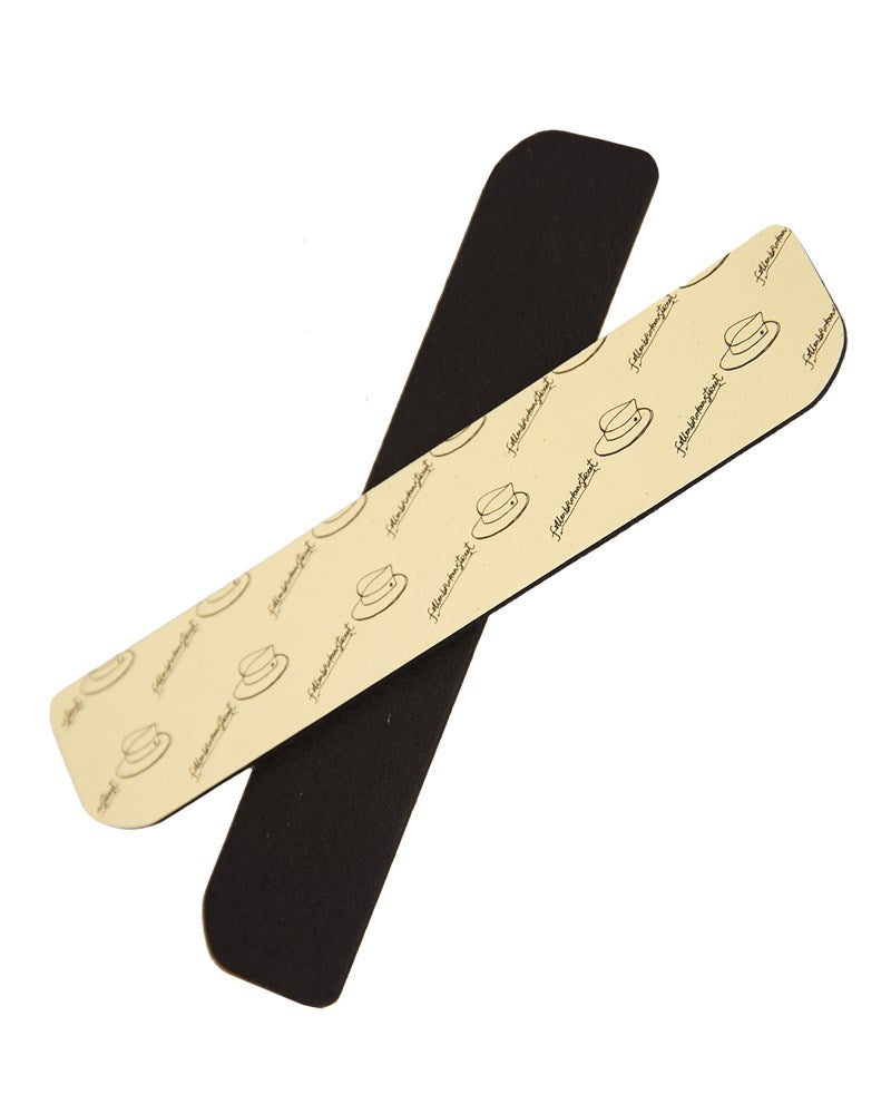 Two strips of hat filler, one with adhesive side visible and the other with a patterned side, presumably to be placed inside a hat to adjust its size.