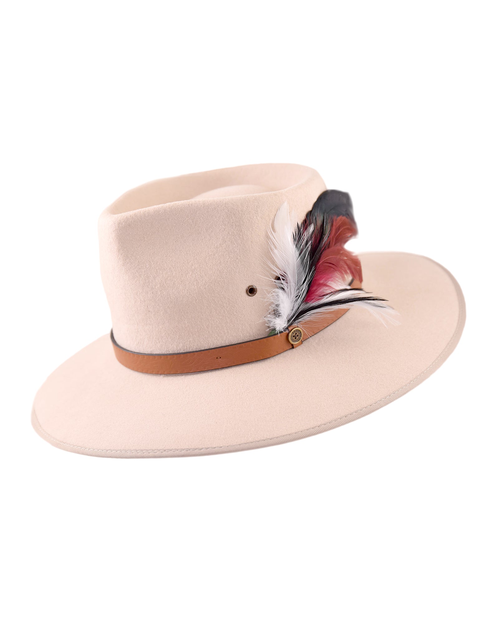 The Drift hat in a soft blush tone with an oversized feather and leather band, shown on white background, exudes individuality and character.
