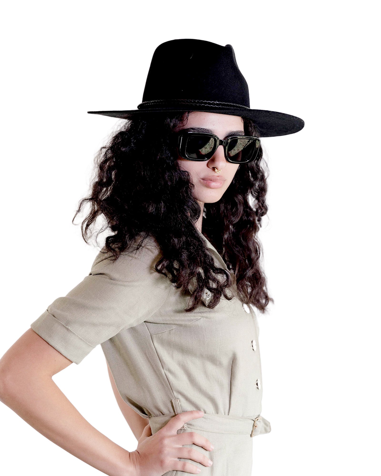 Model wearing the Edison Rancher hat in black with sunglasses and a light shirt, showcasing the hat’s structured crown and bold silhouette in a modern, minimalist styling.