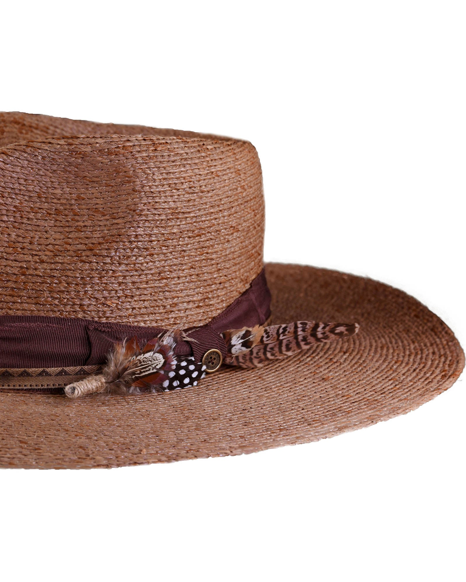 Side profile of the brown straw hat showing the full 12cm brim, vintage ribbon, and layered feather detail. Ideal for outdoor events, festivals, or long sun-drenched days.