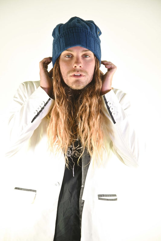 Model wearing the blue Blend Beanie styled with casual layering. Signature ribbed texture and pom-free silhouette gives a relaxed, surf-inspired look. Perfect for festivals, coastal days, or winter warmth in a breathable, lightweight fit.