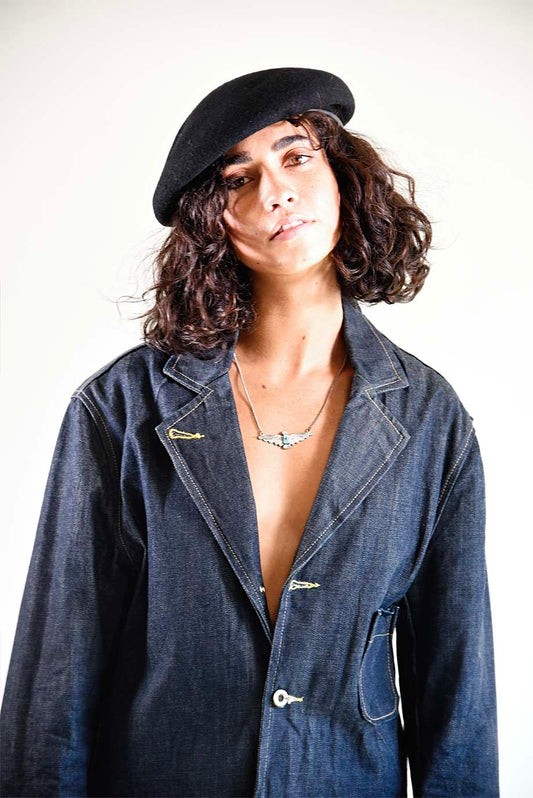 Model wearing The Château Beret styled with a button-down coat, showing timeless cool-weather appeal.