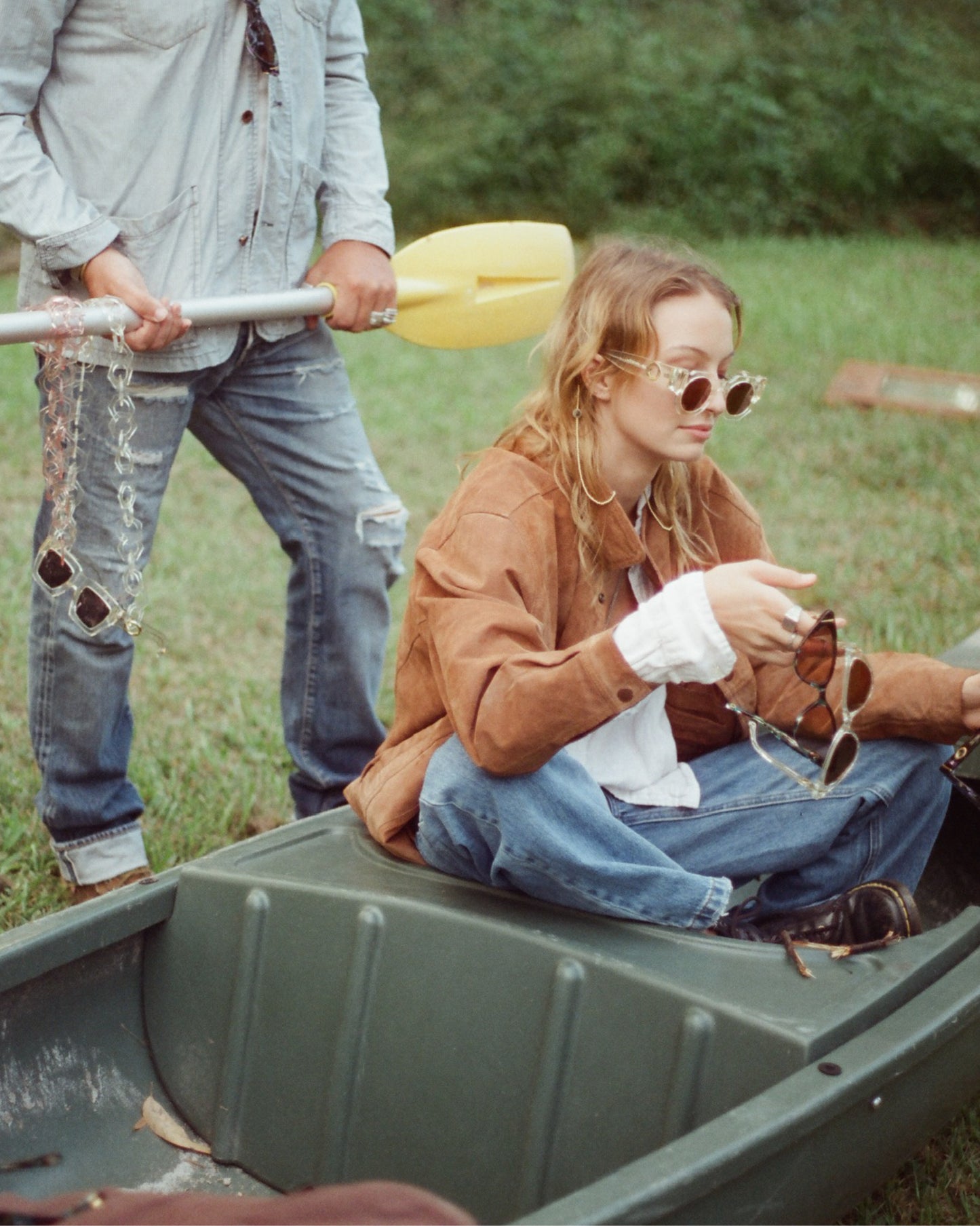 The Cosmos – Skywalker/Amber sunglasses while sitting in a tinny boat. Vintage vibe, relaxed styling, and great engagement value for brand content.