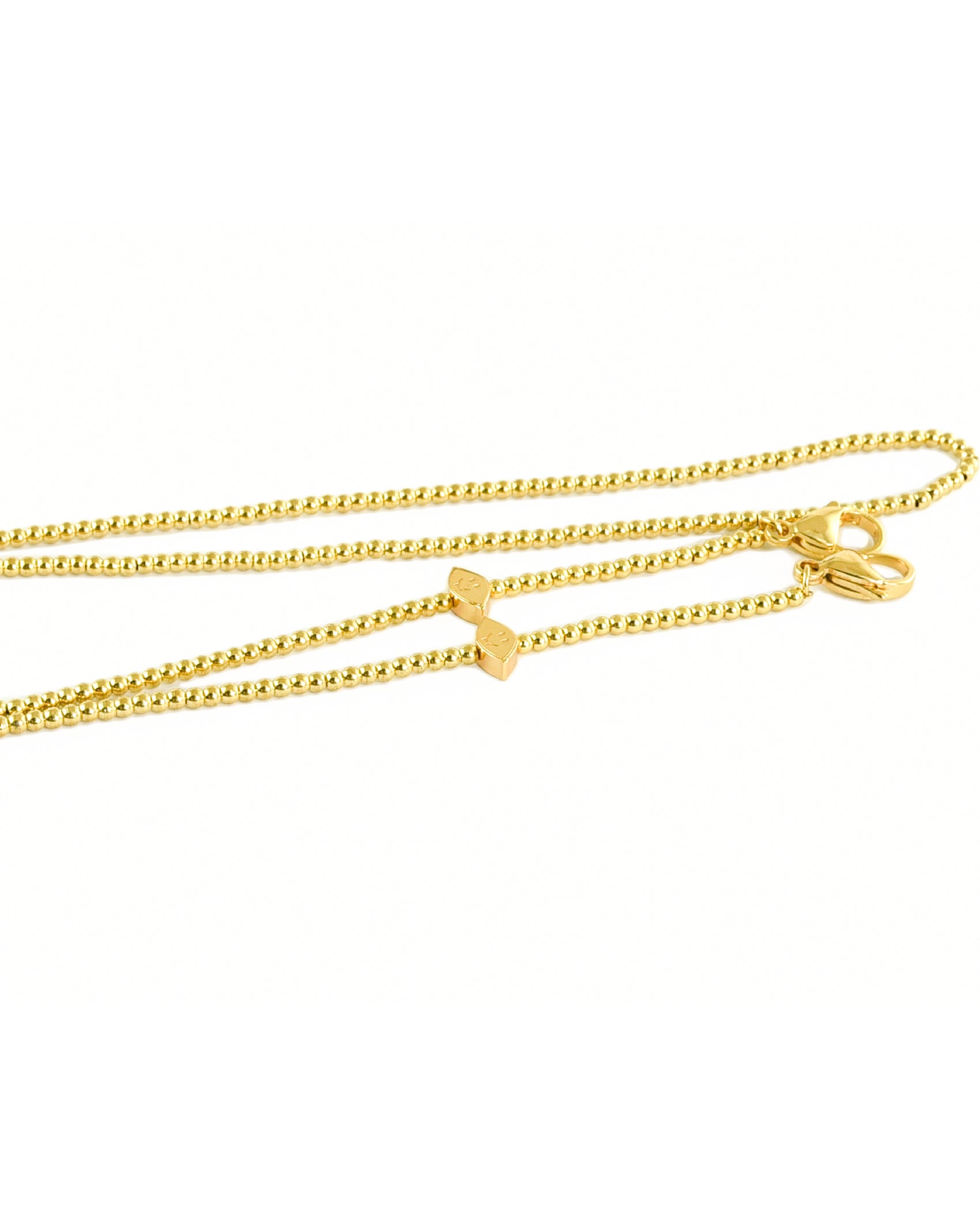 Close-up of gold plated Lemon Head chain  included in the sunglass package.

