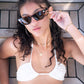 Female model in white crop top adjusting Dope Lemon tortoise shell sunglasses – casual summer vibe.