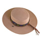 A beige felt hat with a custom ribbon band and a braided leather strap, designed by Angus Stone.