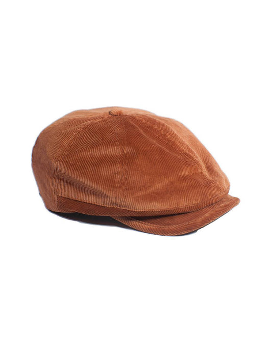 The Bandit Paperboy Cap by FallenBROKENstreet in tan corduroy. Classic 8-panel design with adjustable leather strap, silky lining, and signature metal button. A unisex vintage-inspired cap offering soft texture and timeless street style.