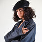 Side profile shot showing the soft structure and curved leather edge of The Château Beret.

