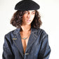 Smiling model in navy layering pieces, showing effortless winter styling with The Château Beret.

