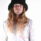 Man wears a fuzzy bucket hat for fallenbrokenstreet