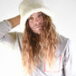man wearing a white bucket hat by fallenbrokenstreet