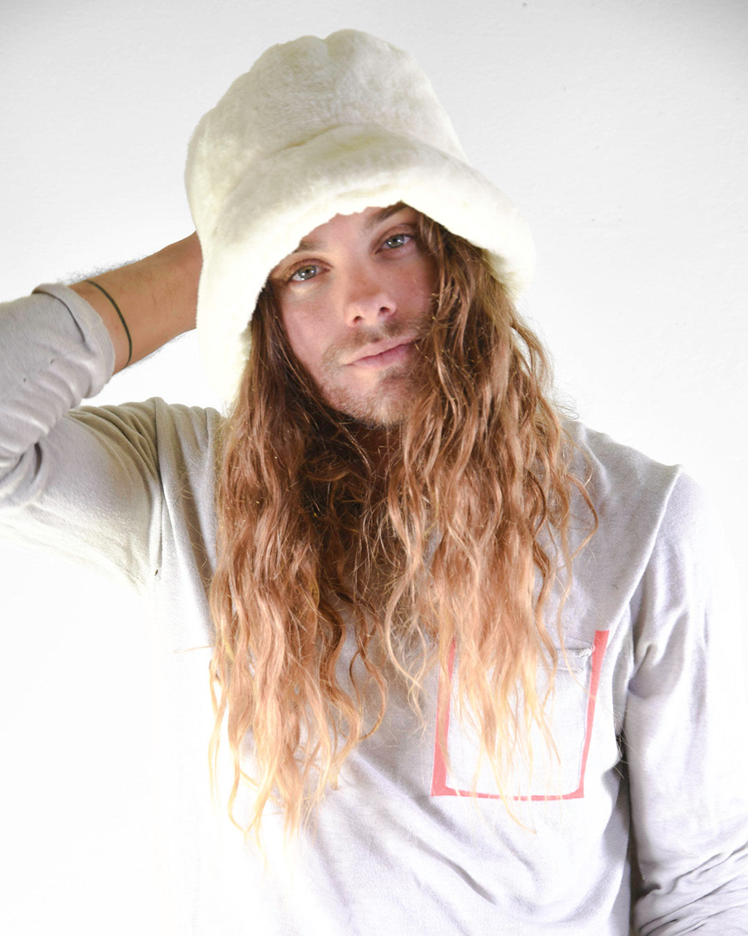 man wearing a white bucket hat by fallenbrokenstreet