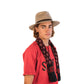 Side profile of The Dingo Felt Hat in Fawn, styled with a bold red tee and scarf. The structured crown and wide brim give the hat a clean, confident line.

