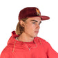 Man Wearing FallenBROKENstreet Stash Cap in Dingo Wine corduroy with stash pocket, embroidery, and signature button.