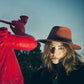 Model wearing The Dingo Felt Hat – Rust outdoors. Unisex wool felt fedora from FallenBROKENstreet featuring leather band and breathable cotton interior.