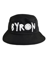 Black cotton bucket hat with bold white 'BYRON' embroidery from Fallenbrokenstreet, photographed from the front. Designed to represent Byron Bay with relaxed style and comfort.

