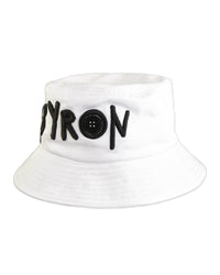 White cotton twill bucket hat featuring bold black "BYRON" embroidery on the front, designed by Fallenbrokenstreet. A lightweight, sun-ready unisex hat representing Byron Bay culture.

