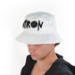 Side profile of model in the Byron embroidered bucket hat. Crisp white fabric contrasts with bold lettering—effortless and iconic.

