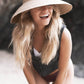 The Holiday Straw Hat by FallenBROKENstreet in natural straw weave. Extra-wide brim, elastic comfort fit, and signature metal button detail. Breathable palm straw hat offering UPF 50+ sun protection for summer escapes.