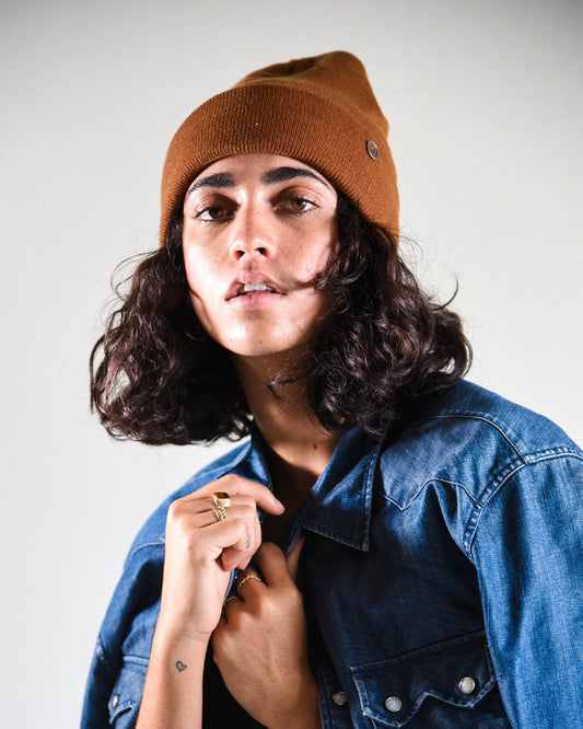 The Lucks Beanie in brown photographed on model, showcasing ribbed knit detail, logo badge, and snug unisex fit. FallenBROKENstreet wool blend beanie offers comfort, warmth, and understated streetwear style, perfect for festivals, coastal living, and layering with outerwear.