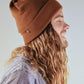 Side profile of The Lucks Beanie in brown, ribbed wool blend with fold-up cuff and logo detail. FallenBROKENstreet accessory photographed on model with denim jacket, showing timeless fit and street-ready look. Soft and warm, ideal for year-round wear from city to coast.