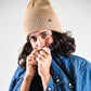 Tan Lucks Beanie in soft wool blend, unisex snug fit, versatile for cooler weather and festivals.